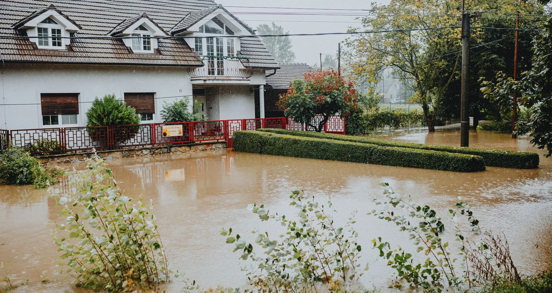 Flood water surrounding homes on a residential street